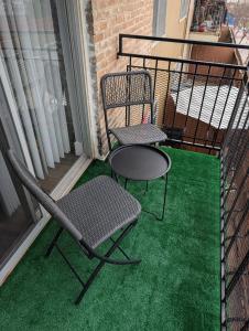 two chairs and a table on a balcony at Entire One Bedroom Condo with AC, Wifi, & Pool in San Antonio