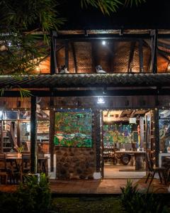 a restaurant with an open door at night at Hotel de selva EL PUENTE in Villa Tunari