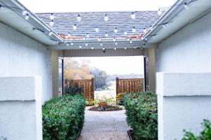 a walkway leading to a patio with a pergola at On Golf Course Peaceful Central Upscale in Columbus