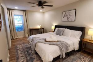 a bedroom with a large bed with a ceiling fan at On Golf Course Peaceful Central Upscale in Columbus