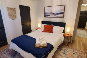 a bedroom with a large bed with a blue blanket at On Golf Course Peaceful Central Upscale in Columbus