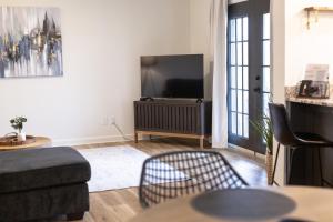 a living room with a couch and a flat screen tv at Golf Course Views, Sunsets & Chill Vibes in Columbus +25 photos
