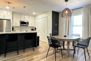 a kitchen and dining room with a table and chairs at Spacious Golf Retreat with Sunset Views in Columbus