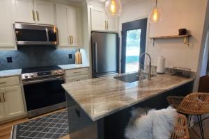 a kitchen with a sink and a counter top at Spacious Golf Retreat with Sunset Views in Columbus