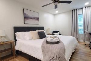 a bedroom with a large bed with a ceiling fan at Spacious Golf Retreat with Sunset Views in Columbus