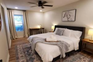 a bedroom with a large bed with a ceiling fan at Spacious Golf Retreat with Sunset Views in Columbus