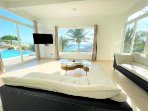 a living room with a couch and a table at Villas & Resort Luz de Luna in Santa Cruz Huatulco +53 photos