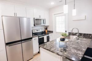 a kitchen with white appliances and a granite counter top at Golf-Side Retreat Calm Central Stylish in Columbus