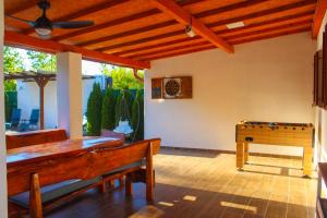 a dining room with a table and a pool table at Vikendica Drinski LAD in Loznica