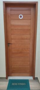 a wooden door with a sign on it at Studio Figueira, Flor in Santarém