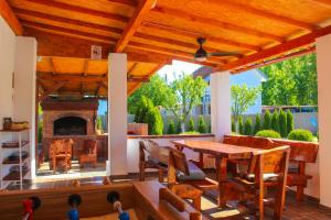 a patio with a table and a fireplace at Vikendica Drinski LAD in Loznica