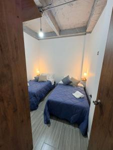 two beds in a room with a door open at Villa Celeste Guaduas El Mirador in Guaduas