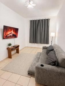 a living room with a couch and a flat screen tv at Casa mezquite in Ocotlán