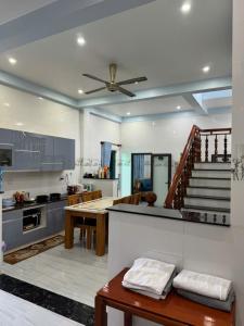 a kitchen with a table and a ceiling fan at KEN Homestay in Cu Lao Thu