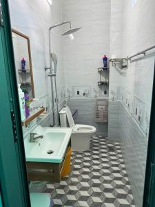 a bathroom with a white toilet and a sink at KEN Homestay in Cu Lao Thu +36 photos