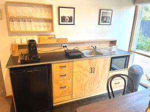 a kitchen with a sink and a stove at Yellow Door Villa in Barwon Heads