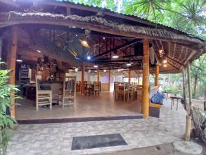 a room with tables and chairs in a building at Big BamBoo Beach Resort Sipalay in Sipalay +164 photos