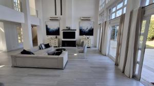 a white living room with a couch and a tv at Golf El Gouna 2 in Hurghada