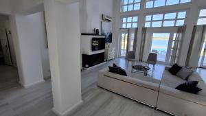 a white living room with a couch and a table at Golf El Gouna 2 in Hurghada