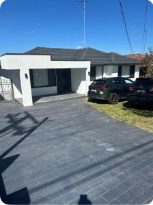 a garage with a car parked in front of a house at Resort-style living -pool in Bass Hill