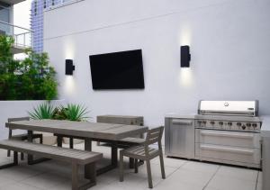 a patio with a table and a television on a wall at The Margot Hotel San Diego Gaslamp Quarter, Outset by Hilton in San Diego