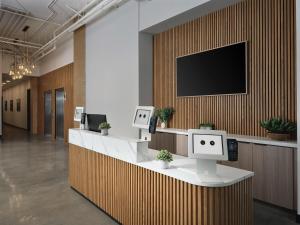 an office lobby with a flat screen tv on a wall at The Margot Hotel San Diego Gaslamp Quarter, Outset by Hilton in San Diego +59 photos