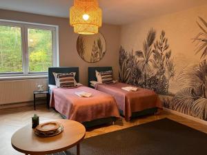 a room with two beds and a table at Very large apartment with private sauna in Stężyca