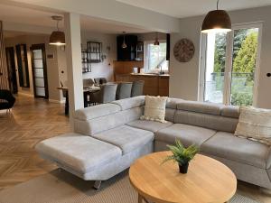 a living room with a couch and a table at Very large apartment with private sauna in Stężyca