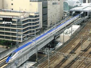 a blue and white train at a train station at Kanazawa Manten Hotel Ekimae in Kanazawa
