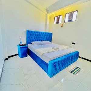 a bedroom with a blue bed in a room at Lavenia Mountain Holiday home in Bandarawela +34 photos