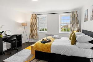 a bedroom with a bed and a desk and window at Cheshire Gold- studio apartment, Warrington in Warrington