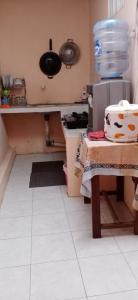 a small kitchen with a table and a stove at Mutiara Dieng in Wonosobo