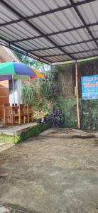 a patio with a table and an umbrella at Mutiara Dieng in Wonosobo