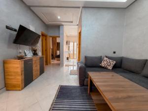 a living room with a couch and a tv at Modern and quiet apartment in Beni Mellal