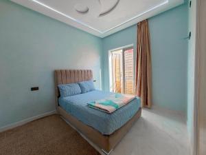 a bedroom with a bed and a window in it at Modern and quiet apartment in Beni Mellal