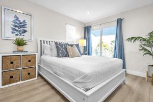 a white bedroom with a bed and a window at Key Largo Kawama villa K1 in Key Largo +31 photos