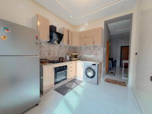 a kitchen with a refrigerator and a washing machine at Modern and quiet apartment in Beni Mellal