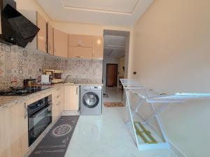 a kitchen with a washer and a washing machine at Modern and quiet apartment in Beni Mellal