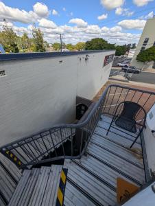 a stairway leading up to a building with a bench at The Gympie Empire in Gympie