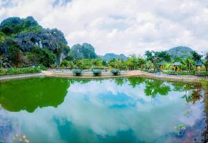 a large body of water with mountains in the background at Hang Mua Eco Park in Ninh Binh