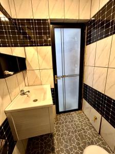 a bathroom with a sink and a shower and a toilet at FOCUS hotel in Baham
