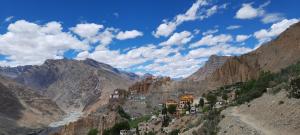 a view of a mountain with a town on a hill at Mochilero Eyrie in Kaza