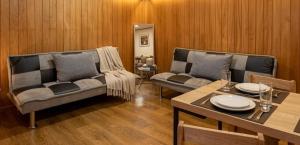 a living room with two couches and a table at Cabañas JP puerto montt in Puerto Montt