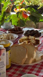 a table with a plate of sandwiches and other foods at Pousada Ferrari Casa Nostra in Santa Teresa +9 photos