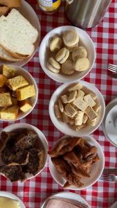 a table topped with bowls of food on a table at Pousada Ferrari Casa Nostra in Santa Teresa