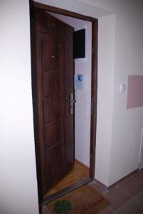 an open wooden door in a room at Apartman Milkovic 2 in Sombor
