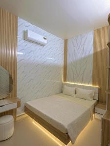 a small bedroom with a bed in a room at SU HOUSE Huế in Hương Trà