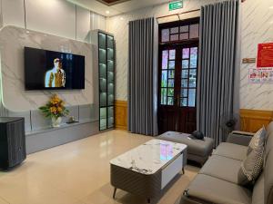 a living room with a couch and a coffee table at SU HOUSE Huế in Hương Trà
