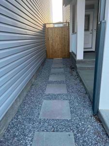 a walkway next to a house with a wall at Charming 1Bd Basement Suite with Private Entrance in Calgary