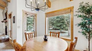 a dining room with a wooden table and a large window at Sunset Cabin in McCall